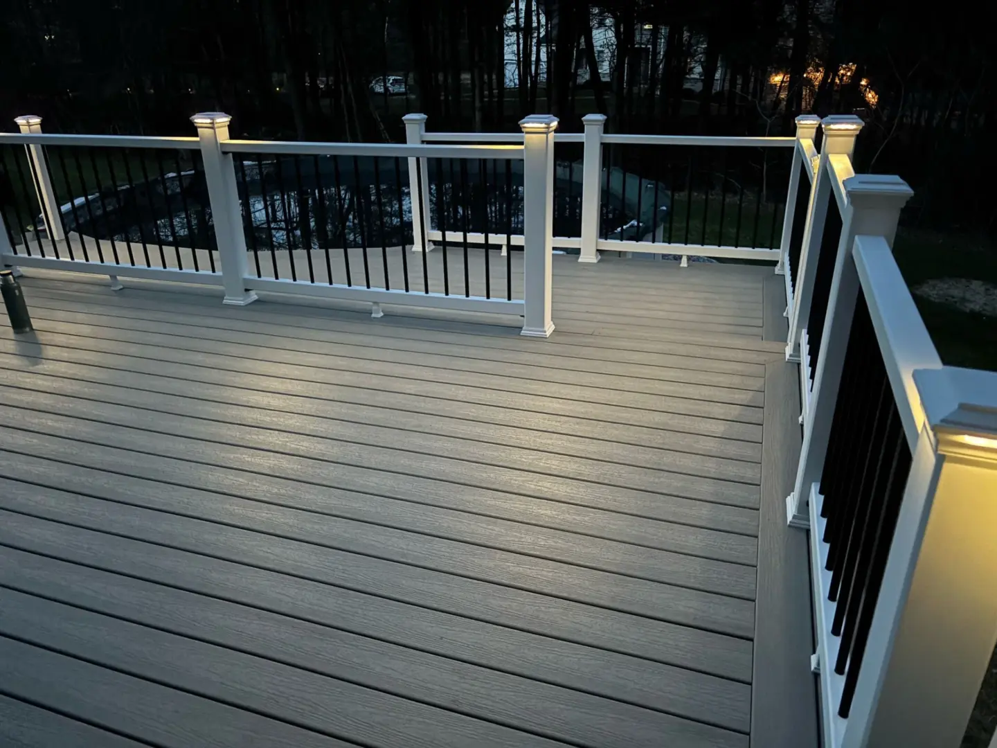 Deck at Night Featuring Railings with Lights